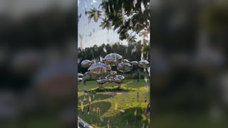 Esta escultura espelhada em aço inoxidável é composta por esferas lisas e arredondadas de tamanhos variados